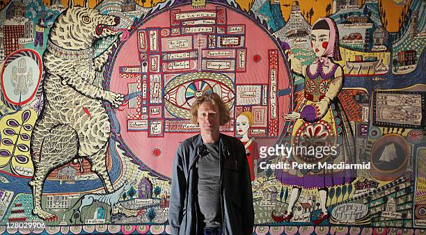Grayson Perry stands in front of his tapestry 'Map of Truths and Beliefs' at The Tomb of the Unknown Craftsman exhibition at the British Museum on...