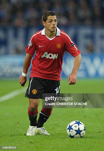 Manchester's Mexican forward Javier Hernandez runs with the ball during the Champions League semi-final, first-leg match of Schalke 04 against...