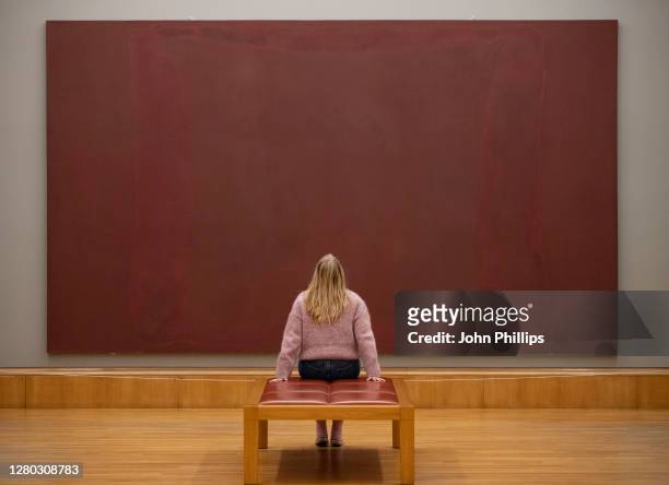 Gallery technician poses next to The Seagram Murals, by artist Mark Rothko during the New Collection Displays photocall at Tate Britain on October...