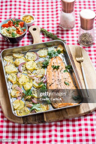 baked salmon filet with potatoes with cous cous side - gebackener lachs stock-fotos und bilder