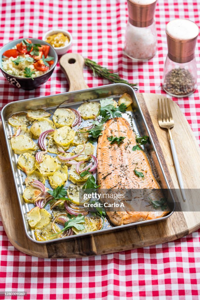 Baked Salmon filet with potatoes with cous cous side