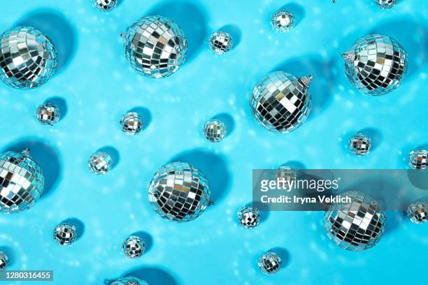 holiday party pattern made of christmas silver disco ball on blue background. - silver disco ball stock pictures, royalty-free photos & images