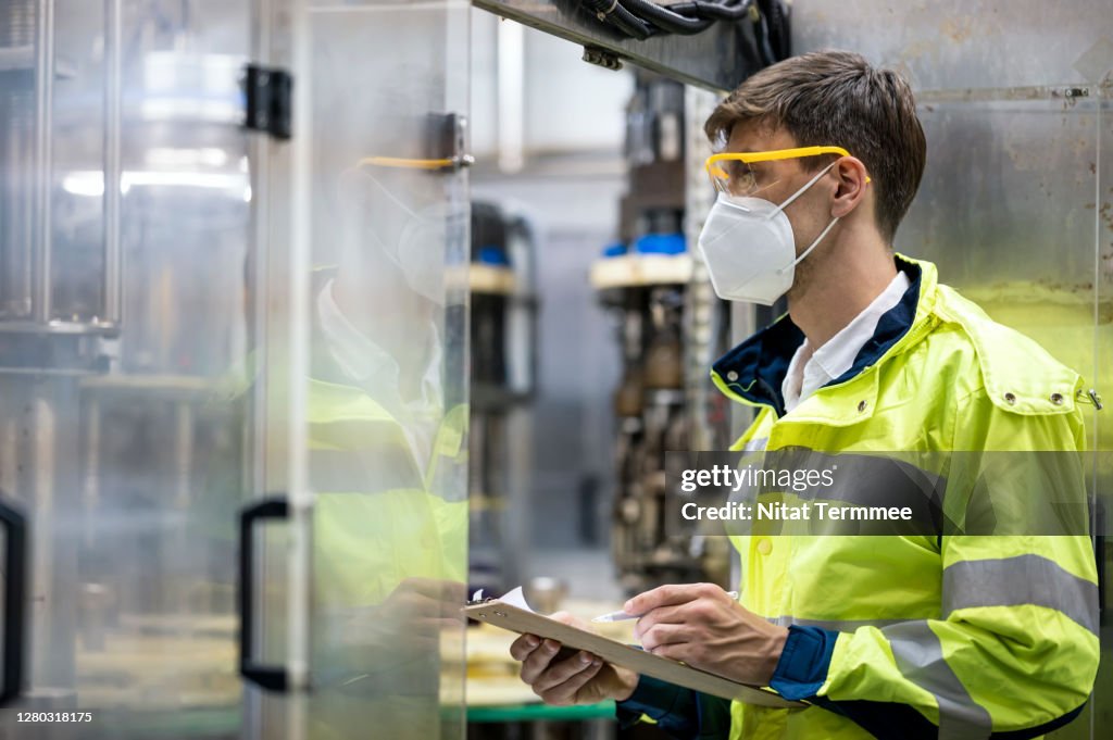 Food and Beverage Factory Male production line operator working at automated conveyor belt. Industry, Business, Processing, Quality Control. Production.
