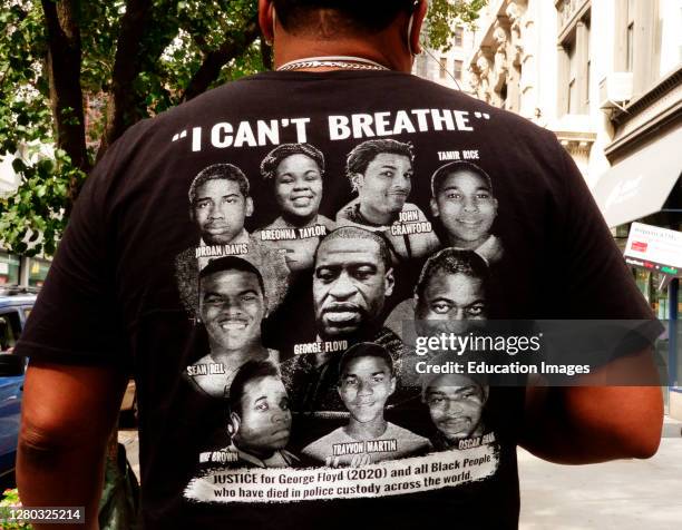 Man wearing an I can't breathe t-shirt with various victims of police violence, Manhattan.