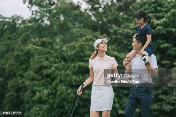 asian chinese young family golfer in green course bonding time while father carry his daughter on shoulder - golf excitement stock pictures, royalty-free photos & images