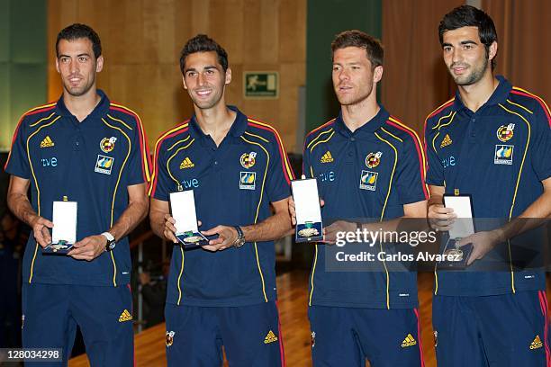 Spanish football team players Sergio Busquets, Alvaro Arbeloa, Xabi Alonso and Raul Albiol pose for the photographers during "Real Orden del Merito...