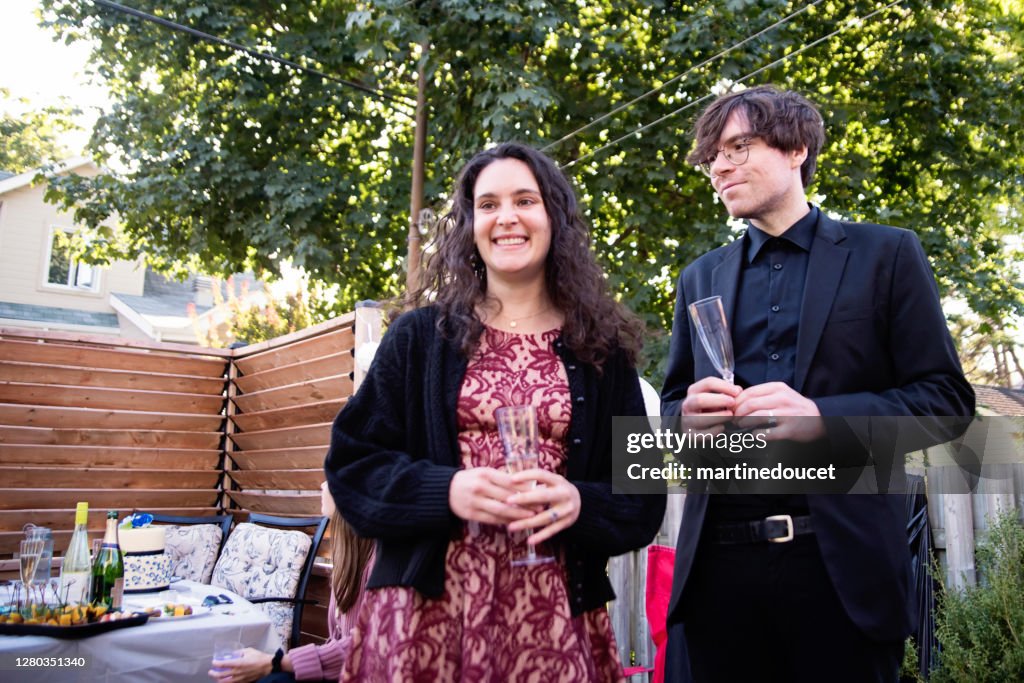 Guests at a wedding cocktail backyard party during Covid-19.