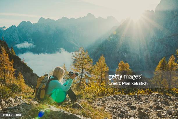 young woman hiking in slovenian alps - travel photographer stock pictures, royalty-free photos & images