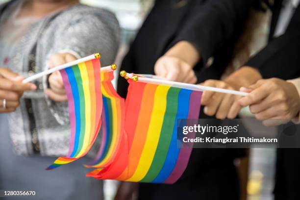 coworkers are celebrating gay pride month with rainbow flags. - regenbogenfahne stock-fotos und bilder