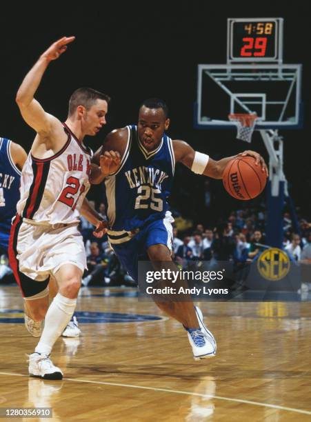 Anthony Epps, Guard for the University of Kentucky Wildcats dribbles the ball past Michael White of the University of Mississippi Ole Miss Rebels...