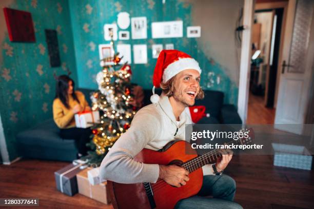 celebrating happiness the christmas at home - christmas singing stock pictures, royalty-free photos & images