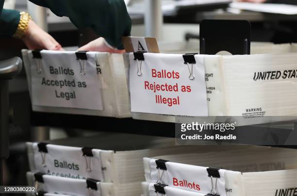 Boxes for Vote-by-Mail ballots that have been rejected or accepted due to signature discrepancies are seen as the Miami-Dade County Canvassing Board...