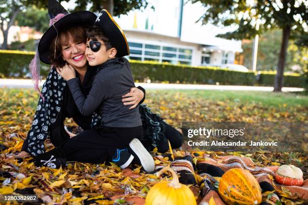 a cute boy hugging his grandma after trick-or-treating - old witch stock pictures, royalty-free photos & images