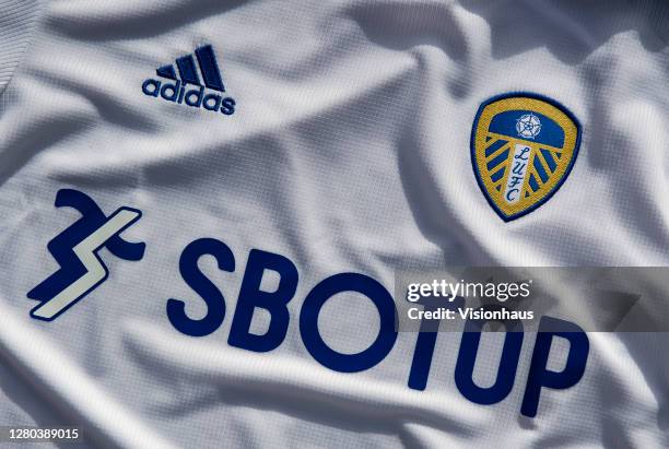 The Leeds United home shirt with kit manufacturers adidas and shirt sponsors, betting brand SBOTOP logos displayed on the front on October 15, 2020...