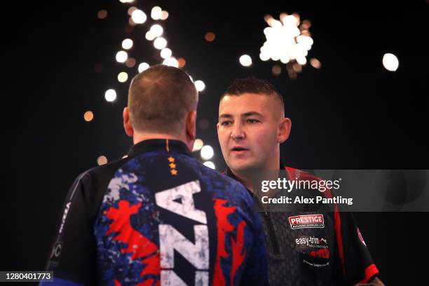 Nathan Aspinall of England embraces Glen Durrant of England ahead of the final during the Unibet Premier League Play-Offs at Ricoh Arena on October...