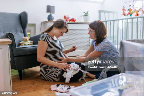 woman feeling movements of baby fresh in nursery room. - prenatal care stockfoto's en -beelden