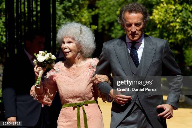 Spain's Duchess of Alba, Maria del Rosario Cayetana Fitz-James-Stuart and her husband Alfonso Diez walk towards photographers after their wedding...