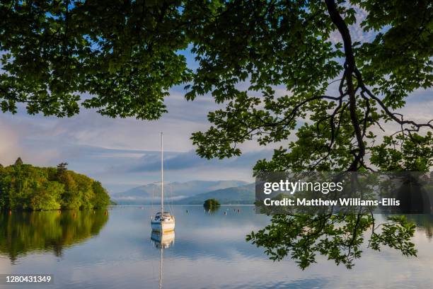 sailing boat floating on lake windermere at sunrise, lake district national park landscape, cumbria, england, uk, europe - lake windermere stock pictures, royalty-free photos & images