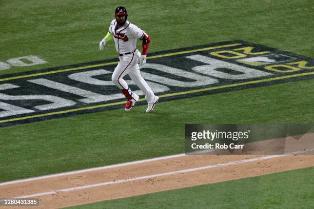 Marcell Ozuna of the Atlanta Braves rounds the bases after hitting a solo home run against the Los Angeles Dodgers during the fourth inning in Game...