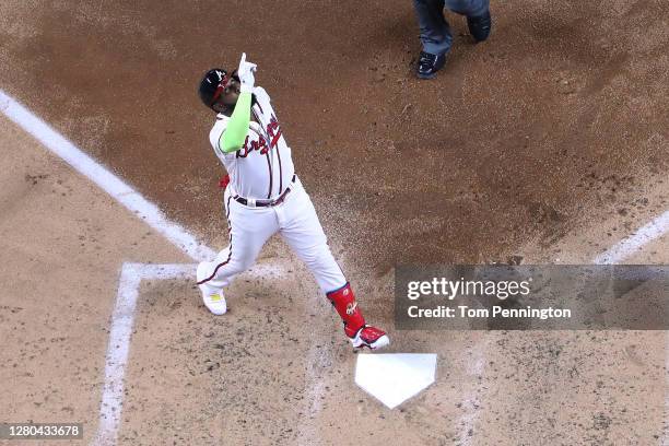 Marcell Ozuna of the Atlanta Braves crosses home plate after hitting a solo home run against the Los Angeles Dodgers during the fourth inning in Game...