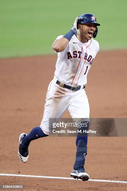 Carlos Correa of the Houston Astros celebrates while rounding the bases after hitting a walk off home run to win 4-3 against Tampa Bay Rays in Game...