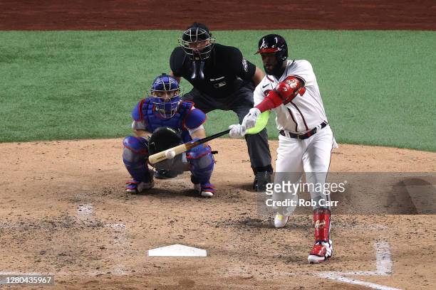 Marcell Ozuna of the Atlanta Braves hits an RBI double against the Los Angeles Dodgers during the sixth inning in Game Four of the National League...