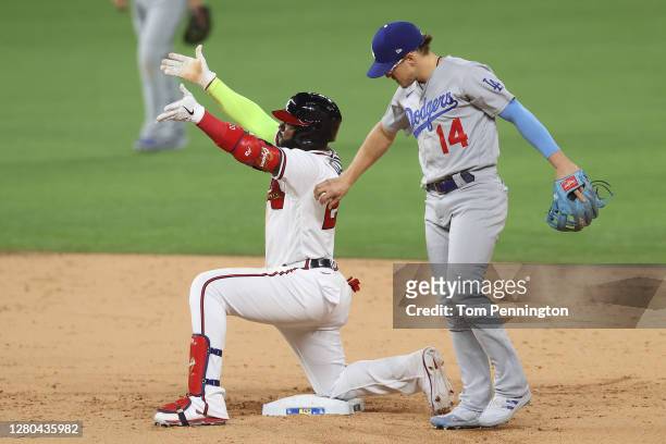 Marcell Ozuna of the Atlanta Braves celebrates after hitting an RBI double against the Los Angeles Dodgers during the sixth inning in Game Four of...