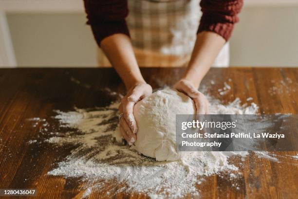 woman kneading bread dough - teig stock-fotos und bilder