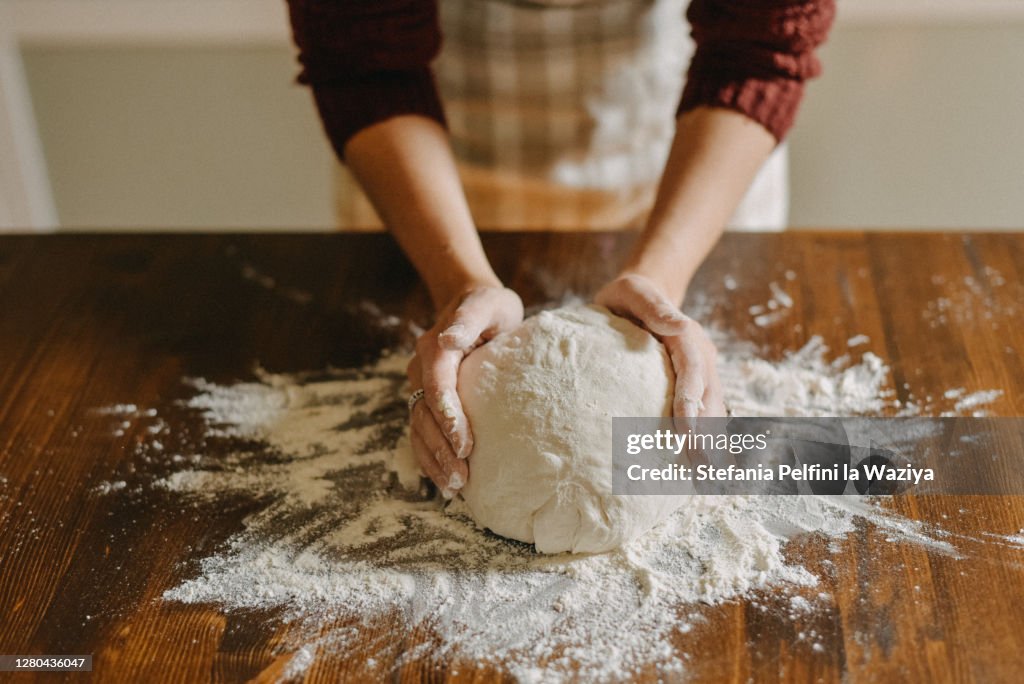 Woman kneading bread dough