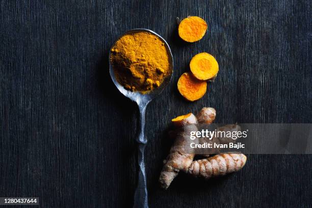 turmeric roots and powder - turmeric stock pictures, royalty-free photos & images