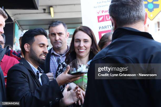 New Zealand Prime Minister Jacinda Ardern takes a selfie with Mandeep Bela of the Network of Migrants and Indian Workers Association while on...