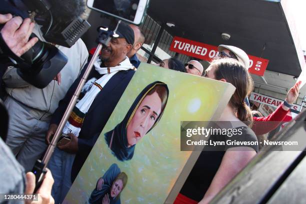 Labour Party staffer holds a portrait of New Zealand Prime Minister Jacinda Ardern in a hijab which was gifted to her by Iraqi refugee Abdelkhalik...