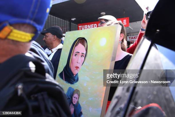 Labour Party staffer holds a portrait of New Zealand Prime Minister Jacinda Ardern in a hijab which was gifted to her by Iraqi refugee Abdelkhalik...