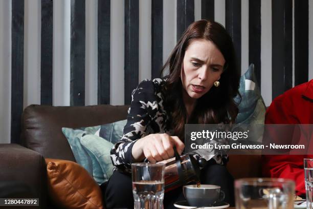 New Zealand Prime Minister Jacinda Ardern makes a cup of tea in an Onehunga Cafe to meet the team from Everybody Eats on October 16, 2020 in...