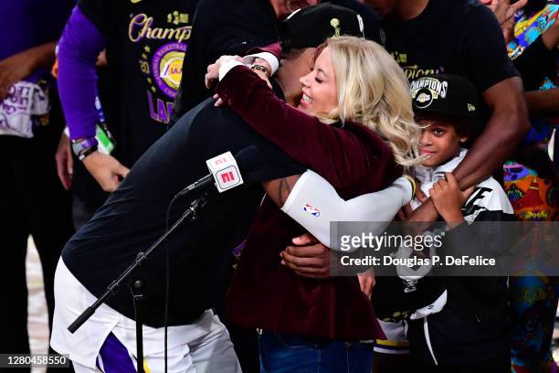 LeBron James and owner Jeanie Buss of the Los Angeles Lakers hug after winning the 2020 NBA Championship Final over the Miami Heat in Game Six of the...
