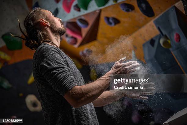man dusting hands with chalk powder - man dusting stock pictures, royalty-free photos & images