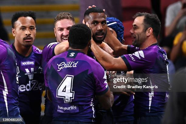 Cameron Smith of the Storm and his team celebrate with Suliasi Vunivalu of the Storm after he scored a try during the NRL Preliminary Final match...