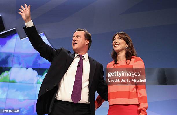 British Prime Minister David Cameron and his wife Samantha react after delivering his keynote speech to delegates at the annual Conservative Party...