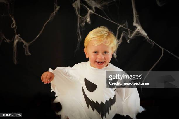little boy in ghost costume on halloween - ghost player stock pictures, royalty-free photos & images