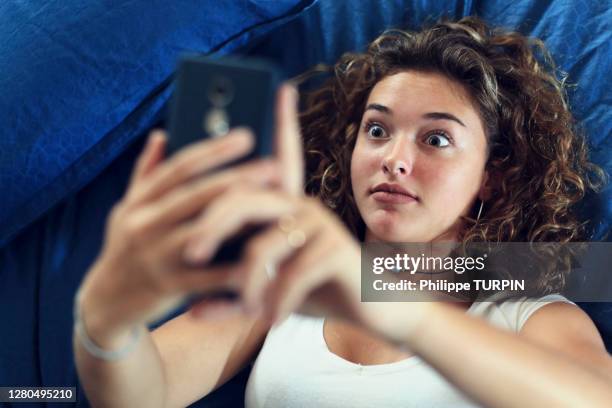 teenage girl and everyday life. in bed with smartphone - image effect stock pictures, royalty-free photos & images