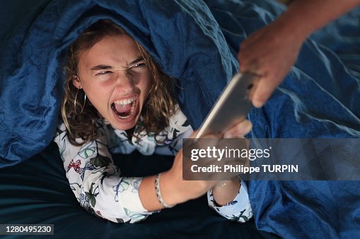 Teenage girl and everyday life. In bed with smartphone Teenage girl and everyday life. In bed with smartphone