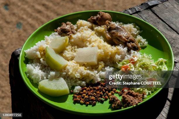 local dish in a plate and drying rice on the background, khonoma, nagaland, india - nagaland food stock pictures, royalty-free photos & images