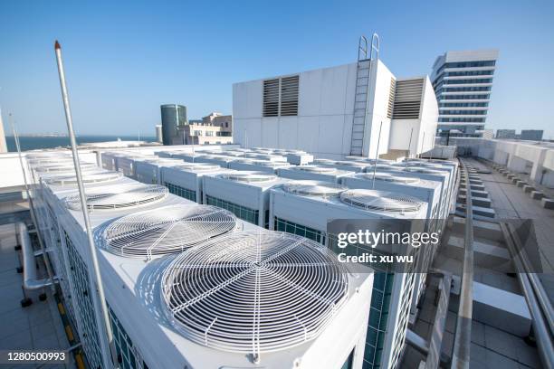 central air-conditioning compressor on top of office building - hvac stock pictures, royalty-free photos & images