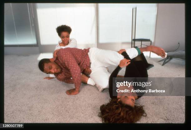 American actress Robin Givens , her husband, heavyweight boxer Mike Tyson, and her mother, Ruth, roll around on the floor of their new home, Los...
