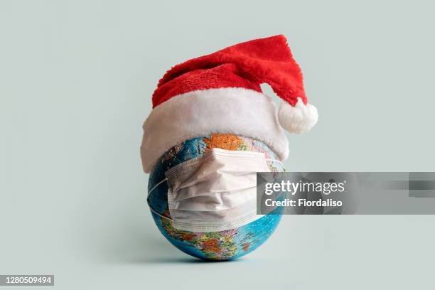 globe made of jigsaw puzzles with a protective medical mask - world café stock pictures, royalty-free photos & images