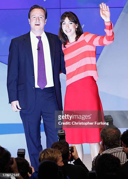 British Prime Minister David Cameron and his wife Samantha react after delivering his keynote speech to delegates at the annual Conservative Party...