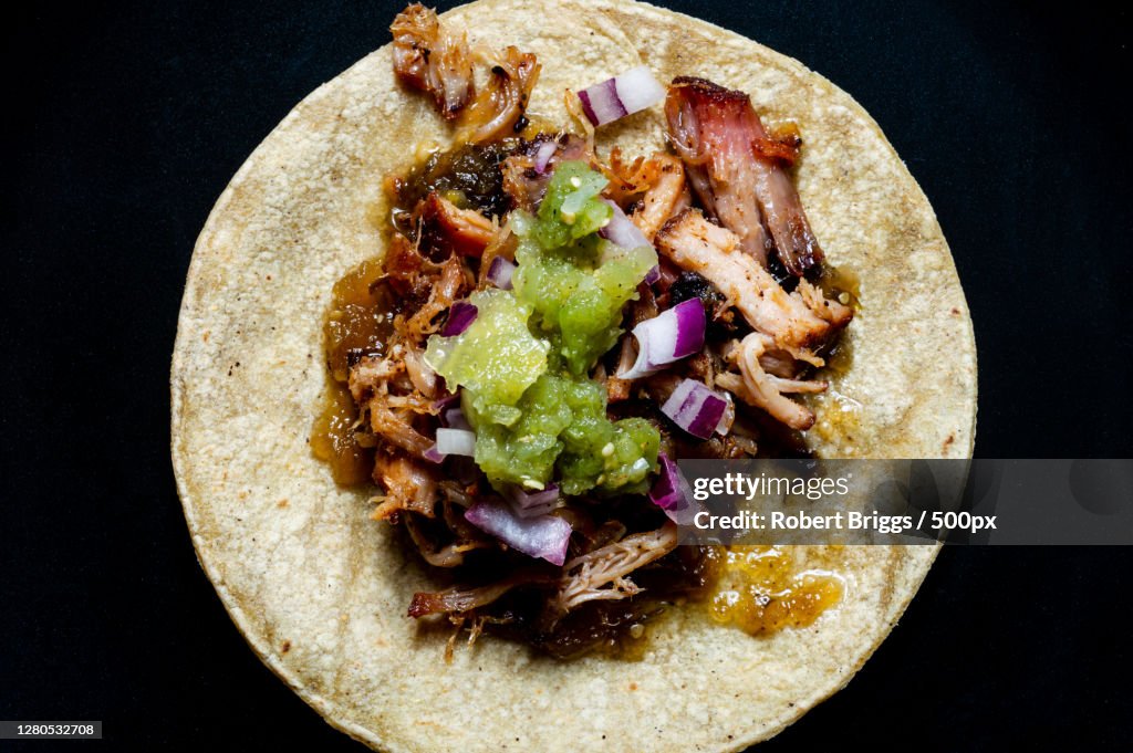 Directly above shot of food in plate on black background