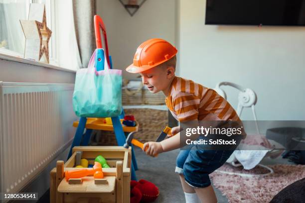 young boy playing dress up - boy in hard hat stock pictures, royalty-free photos & images