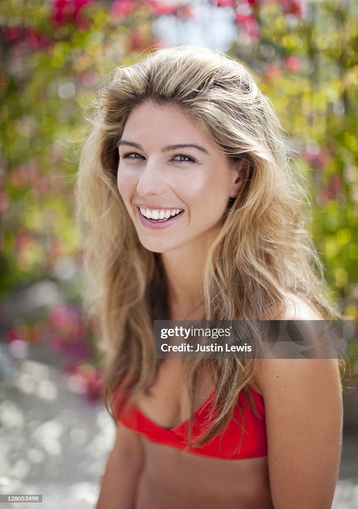 Young woman smiling in bathing suit in sun