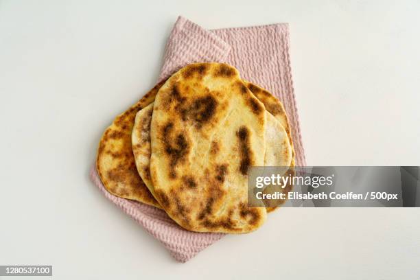 directly above shot of bread on white background - naan stock pictures, royalty-free photos & images